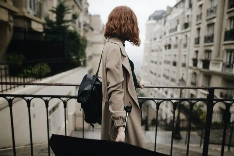 shallow focus photography of woman beside fence