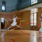 twins doing rhythmic gymnastics