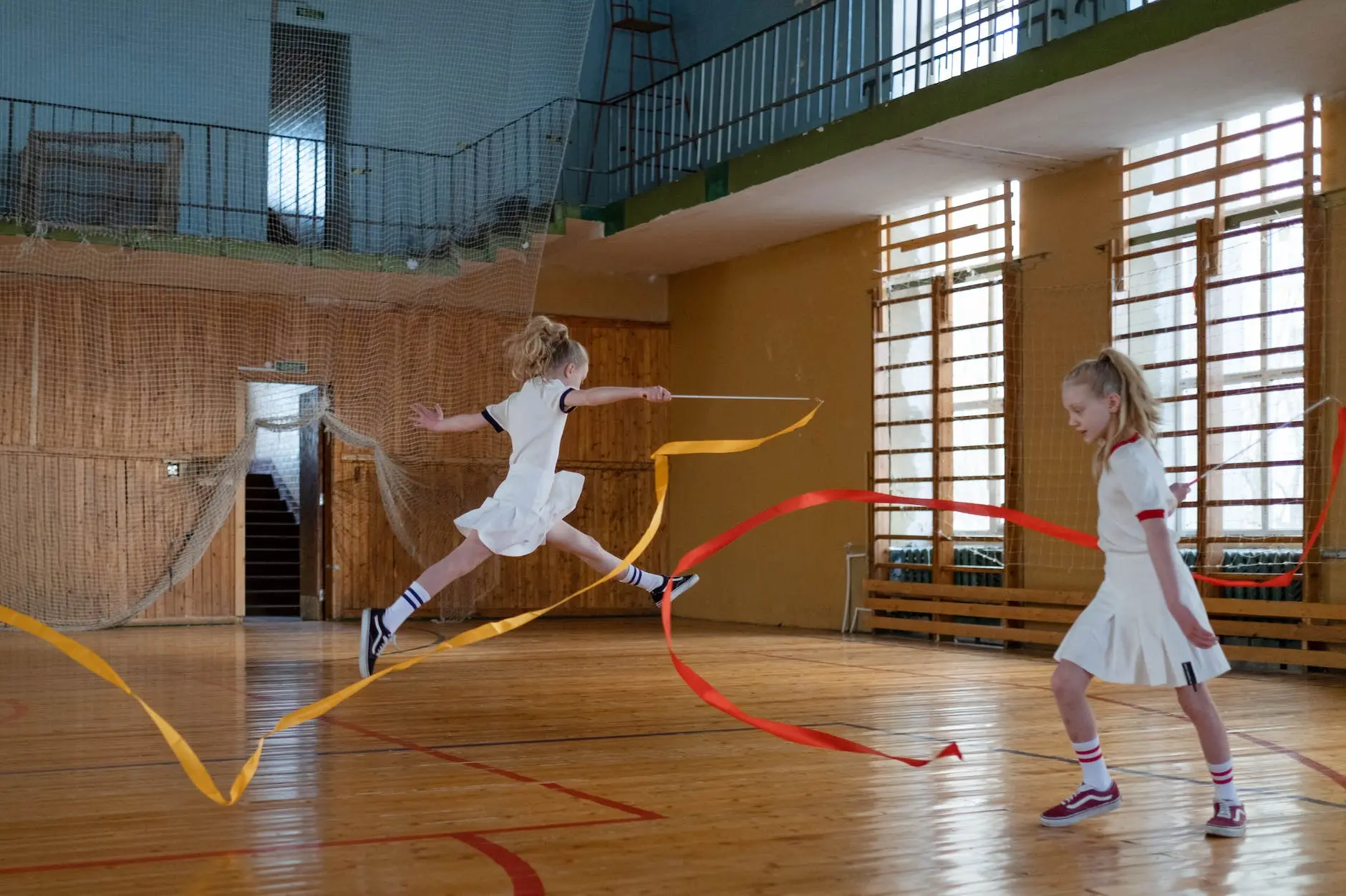 twins doing rhythmic gymnastics